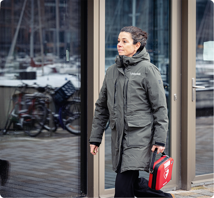 A person carrying a portable AED, showing how easy it is to bring life-saving technology to a cardiac arrest.